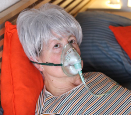 elderly woman wearing a breath mask