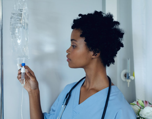 female nurse checking iv packet
