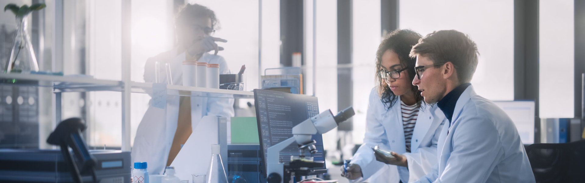 three researchers in a lab setting